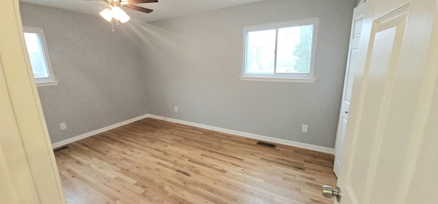 empty room featuring ceiling fan and light hardwood / wood-style flooring