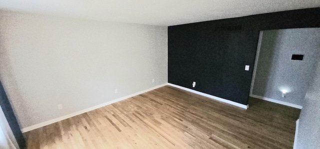 empty room featuring hardwood / wood-style flooring