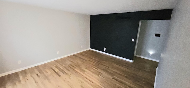 unfurnished room with hardwood / wood-style floors