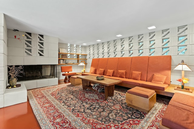 living room featuring a tiled fireplace