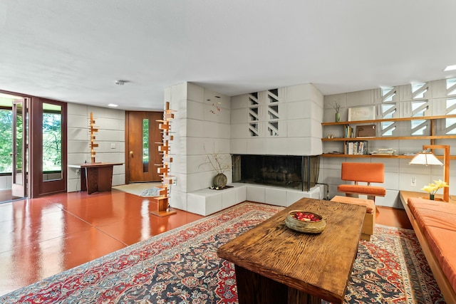 living room featuring a tile fireplace