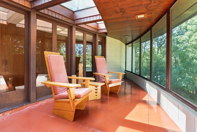 unfurnished sunroom featuring a skylight