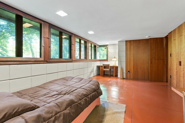 bedroom with wood walls