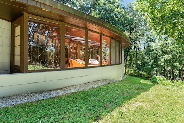 view of side of home with a sunroom