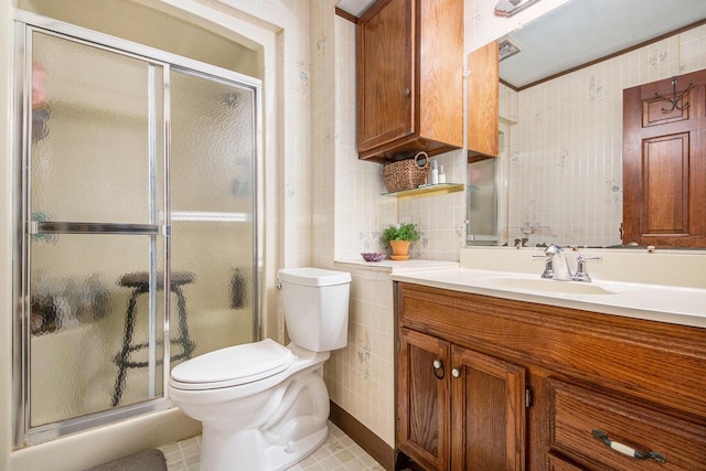 bathroom with a shower with door, vanity, and toilet