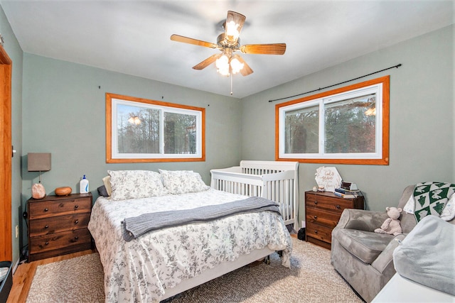 bedroom with ceiling fan and light hardwood / wood-style flooring