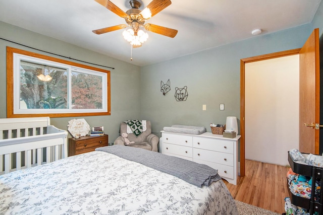 bedroom with light hardwood / wood-style flooring and ceiling fan