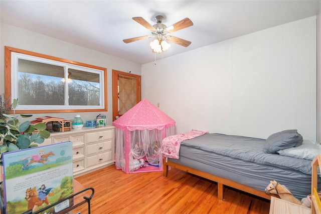 bedroom with ceiling fan and light hardwood / wood-style floors