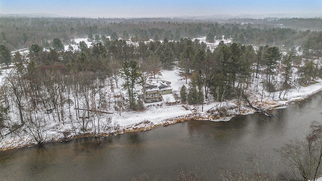 snowy aerial view featuring a water view