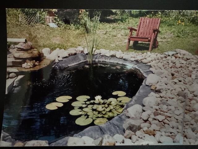 exterior details with a small pond