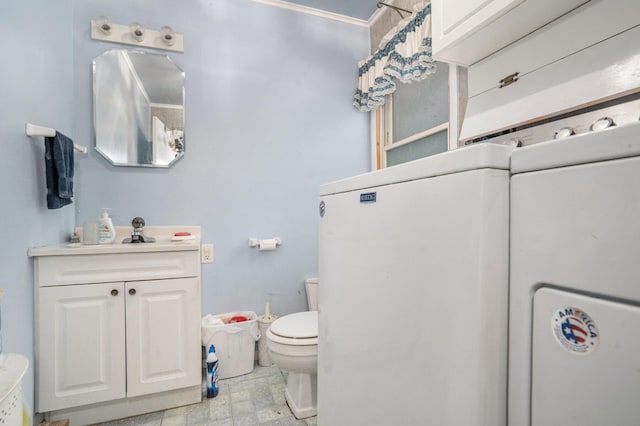 bathroom featuring vanity and toilet