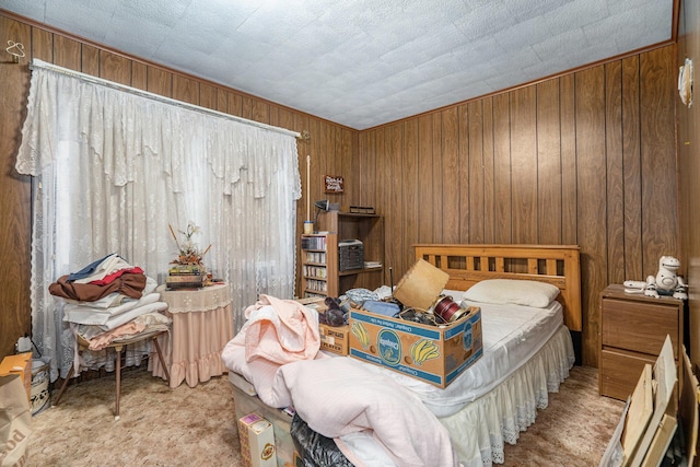 bedroom with light carpet and wood walls