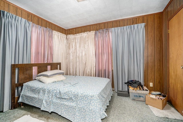 carpeted bedroom with wooden walls