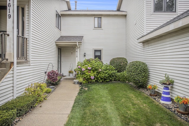 doorway to property featuring a lawn