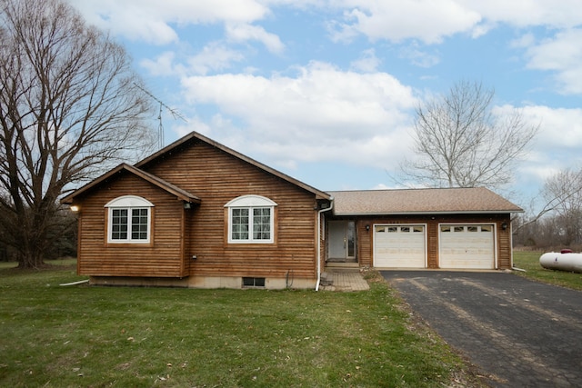 ranch-style home featuring a front lawn and a garage