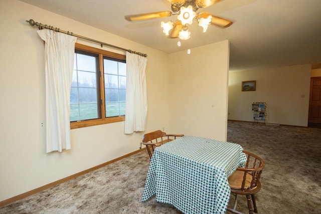 carpeted dining space featuring ceiling fan