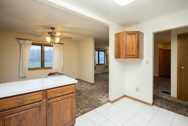 kitchen with light colored carpet and ceiling fan