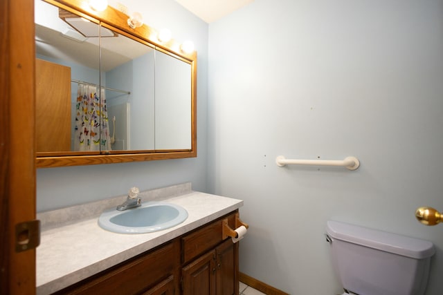 bathroom featuring vanity, curtained shower, and toilet