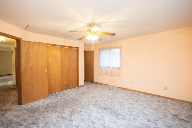 unfurnished bedroom featuring carpet, ceiling fan, and a closet