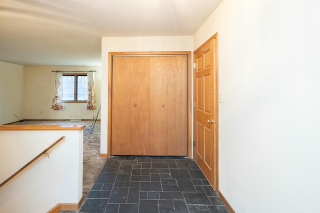 hallway with a textured ceiling