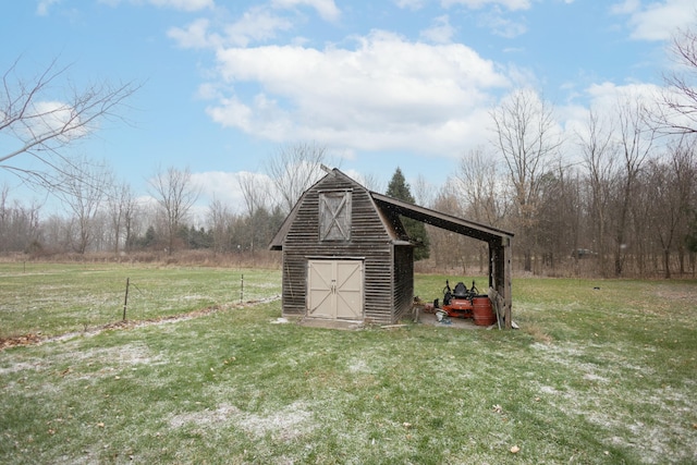 view of outdoor structure featuring a yard and a rural view