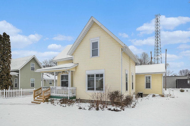 view of snow covered rear of property