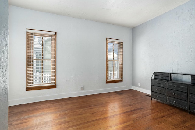 unfurnished bedroom featuring dark hardwood / wood-style flooring