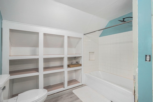 bathroom featuring shower / bathing tub combination, toilet, lofted ceiling, and wood-type flooring