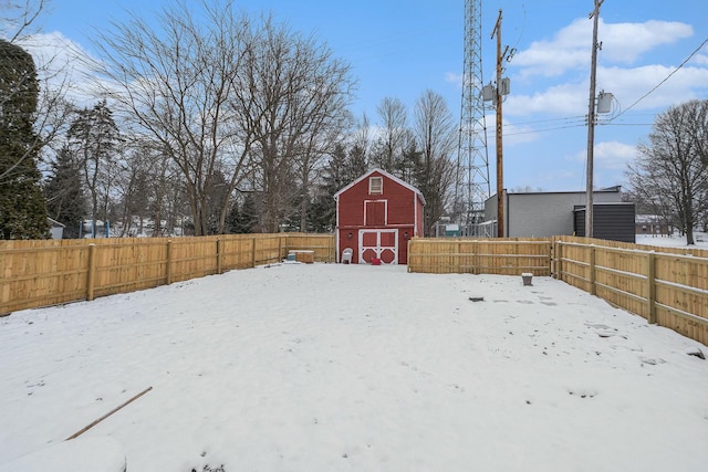 yard layered in snow with an outdoor structure