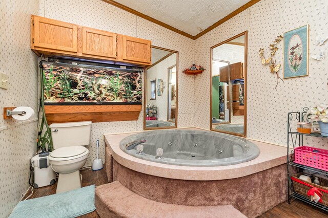 bathroom featuring a bath, ornamental molding, a textured ceiling, toilet, and hardwood / wood-style flooring