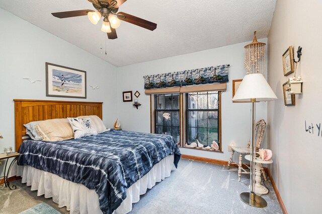 bedroom featuring carpet, ceiling fan, lofted ceiling, and a textured ceiling