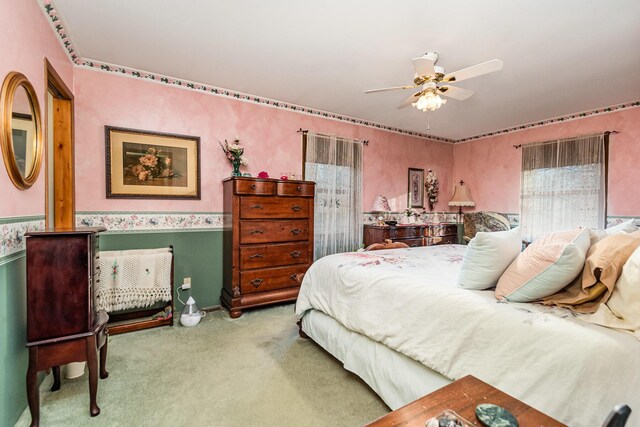 bedroom featuring ceiling fan and light carpet