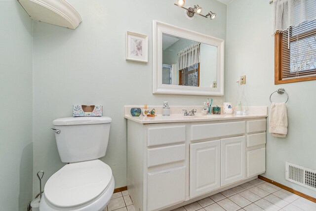 bathroom with tile patterned flooring, vanity, and toilet