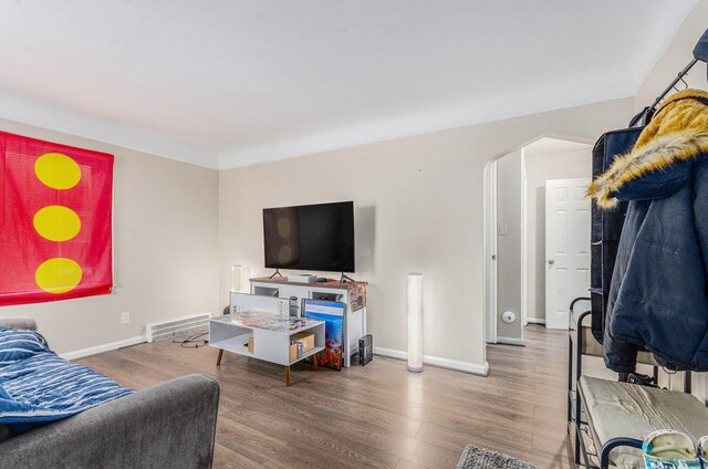 living room featuring crown molding and hardwood / wood-style floors