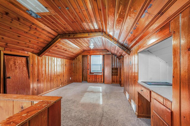 additional living space featuring lofted ceiling, light colored carpet, wooden walls, and wood ceiling