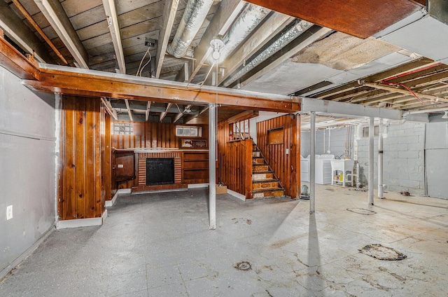 basement featuring washer and clothes dryer and a fireplace