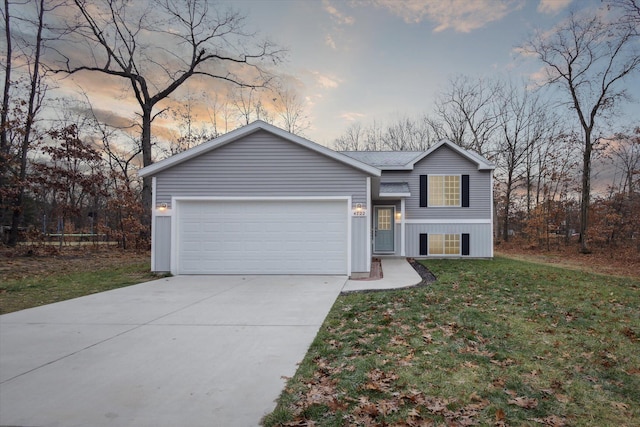 view of front facade with a lawn and a garage