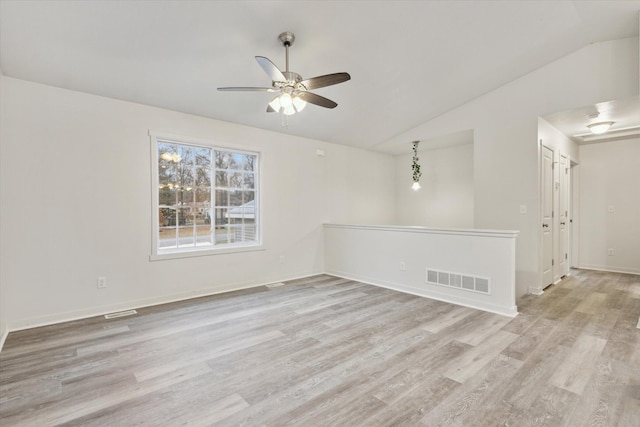 empty room featuring ceiling fan, light hardwood / wood-style floors, and lofted ceiling