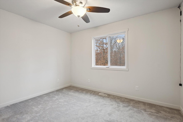 spare room featuring ceiling fan and carpet floors