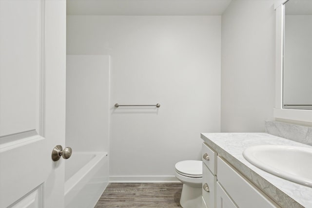 bathroom featuring hardwood / wood-style floors, vanity, and toilet