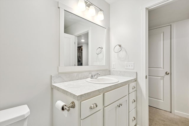 bathroom with vanity and toilet