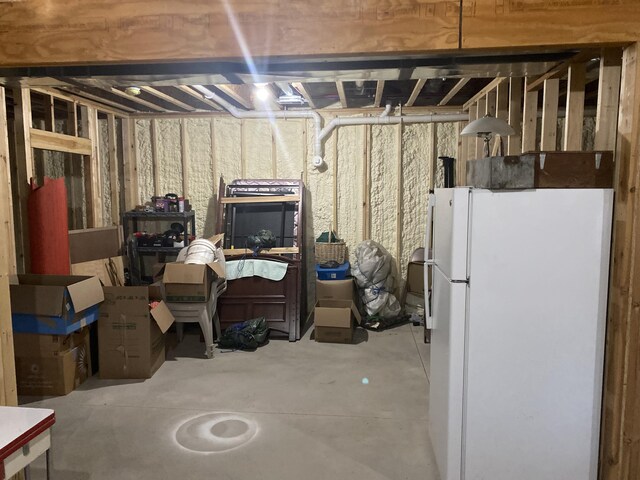 basement featuring white fridge