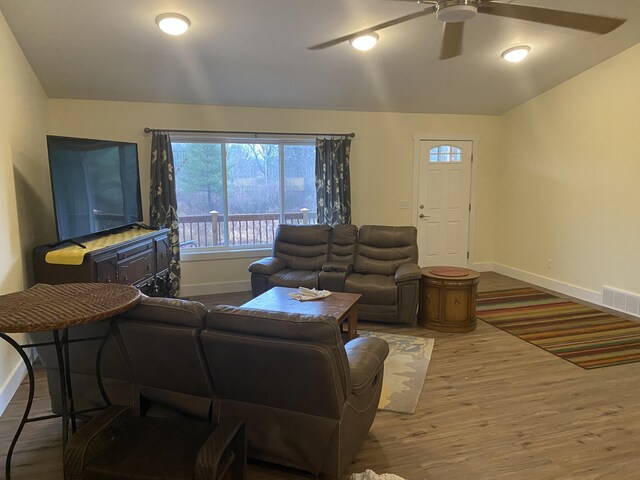 living room with ceiling fan and wood-type flooring