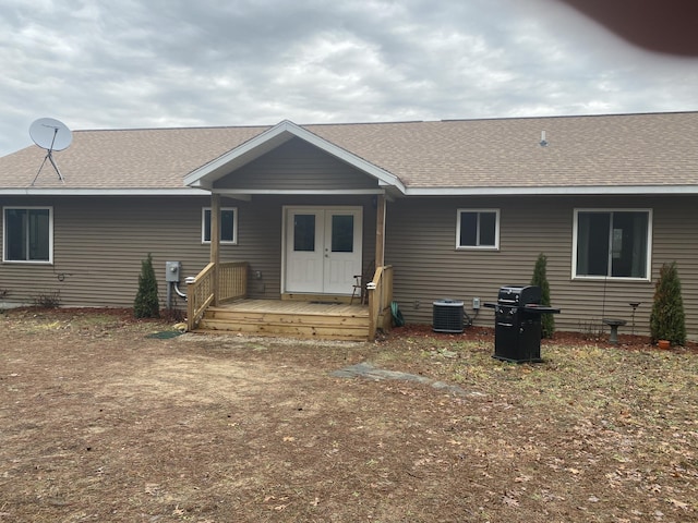 rear view of property featuring a deck and central AC unit