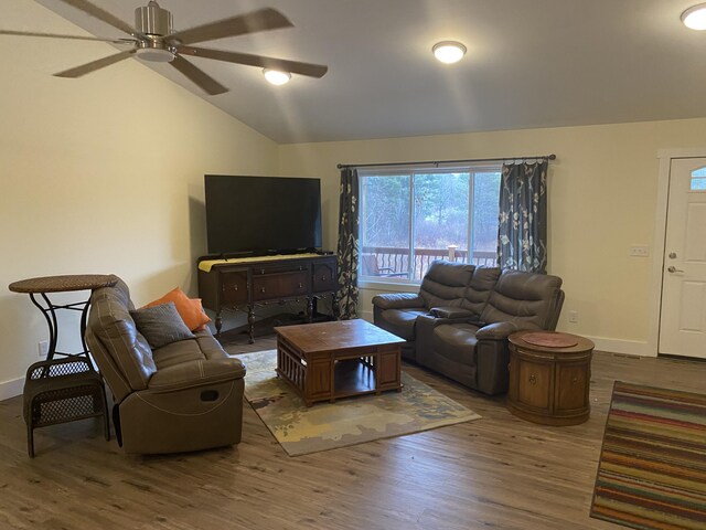 living room with wood-type flooring, ceiling fan, and lofted ceiling