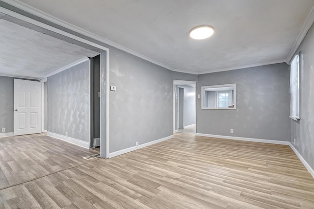 unfurnished room featuring light hardwood / wood-style floors and crown molding