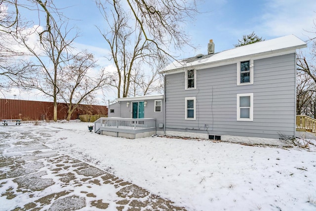 snow covered property with a wooden deck