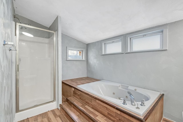 bathroom featuring separate shower and tub, vaulted ceiling, and hardwood / wood-style flooring