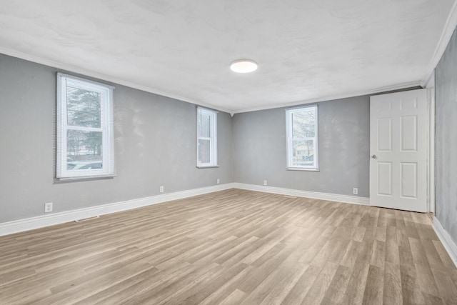 basement featuring crown molding and light hardwood / wood-style floors