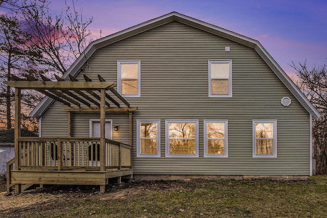 back house at dusk featuring a pergola